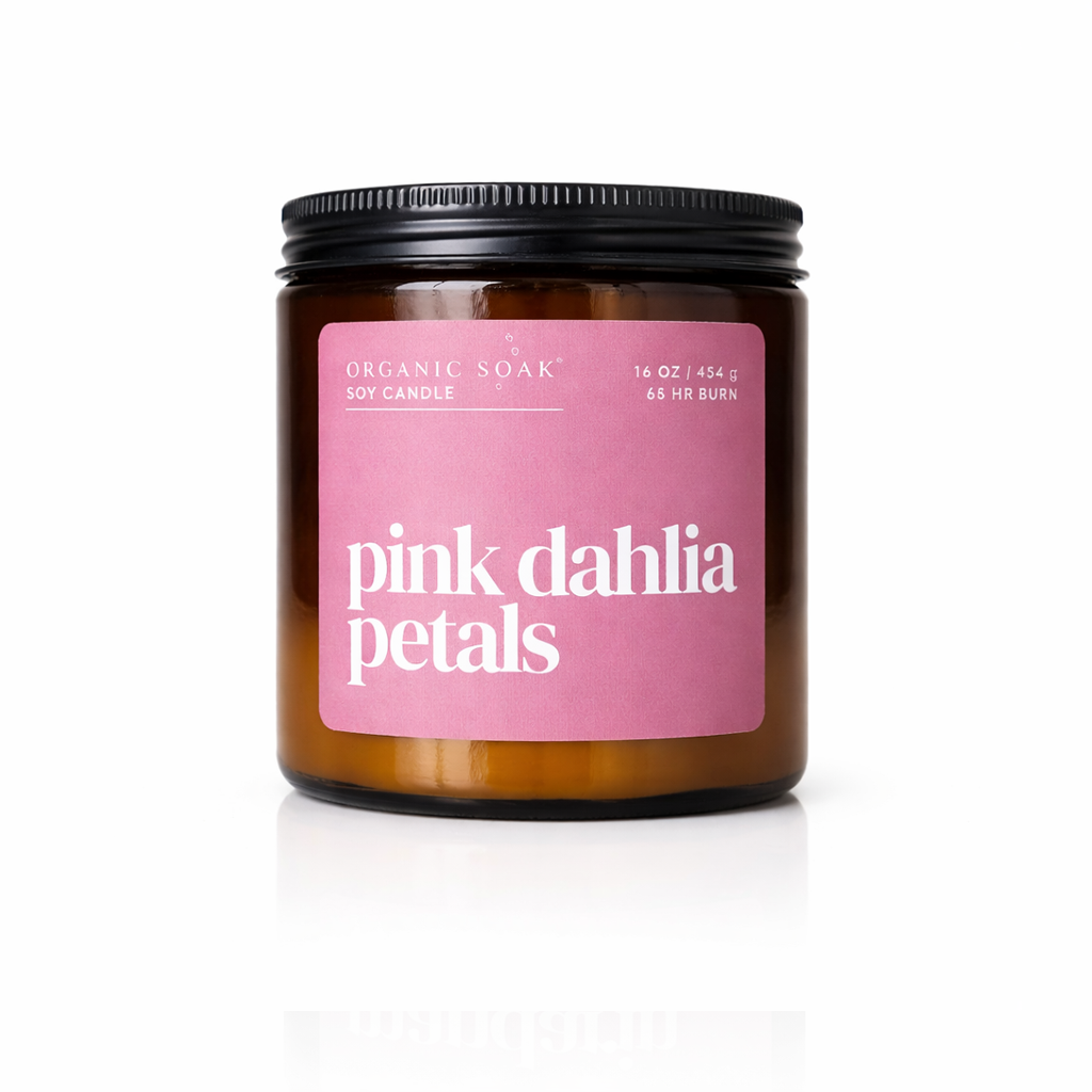 Candle jar with pink label reading &