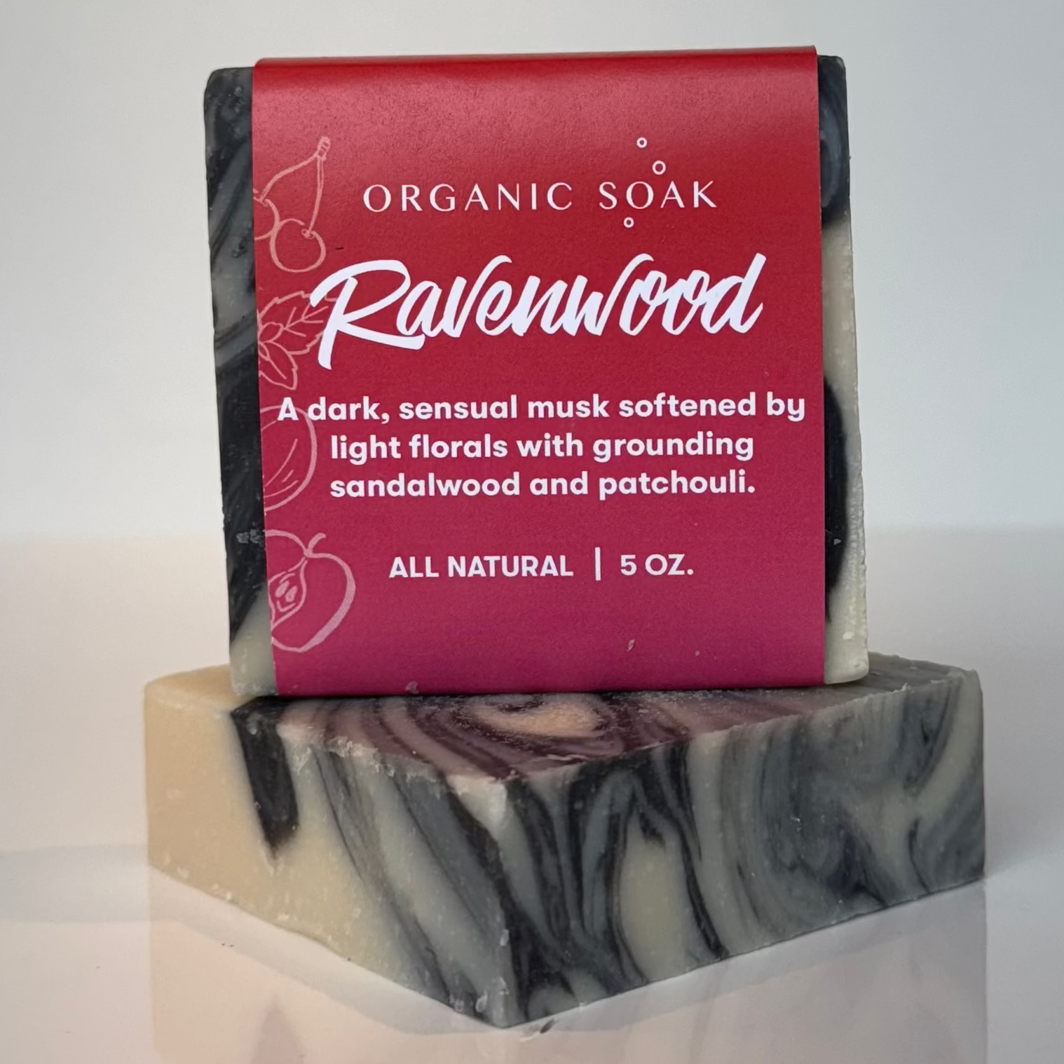 Bar of soap with a red label on a marble stand against a white background