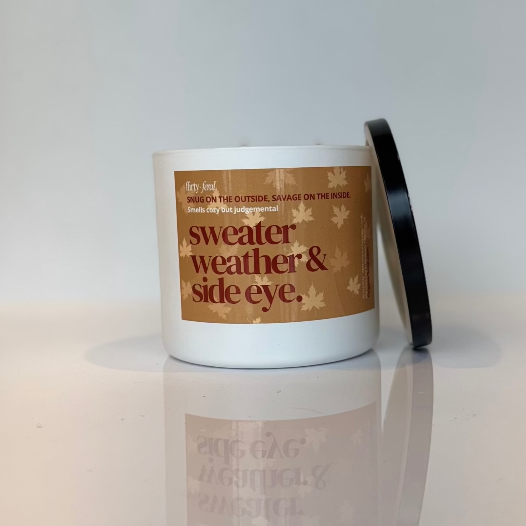 Candle with a label on a reflective surface