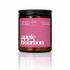 An Organic Soak soy candle in an amber glass jar with a black lid and a pink label reading &