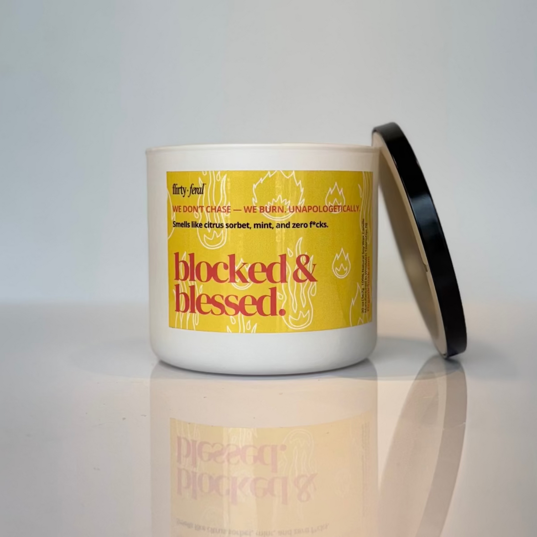 Candle with a yellow label on a reflective surface