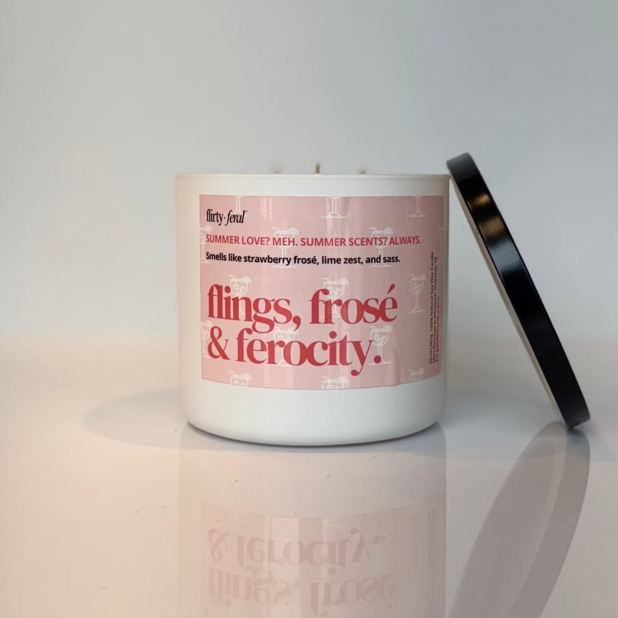 Candle with a pink label on a white surface