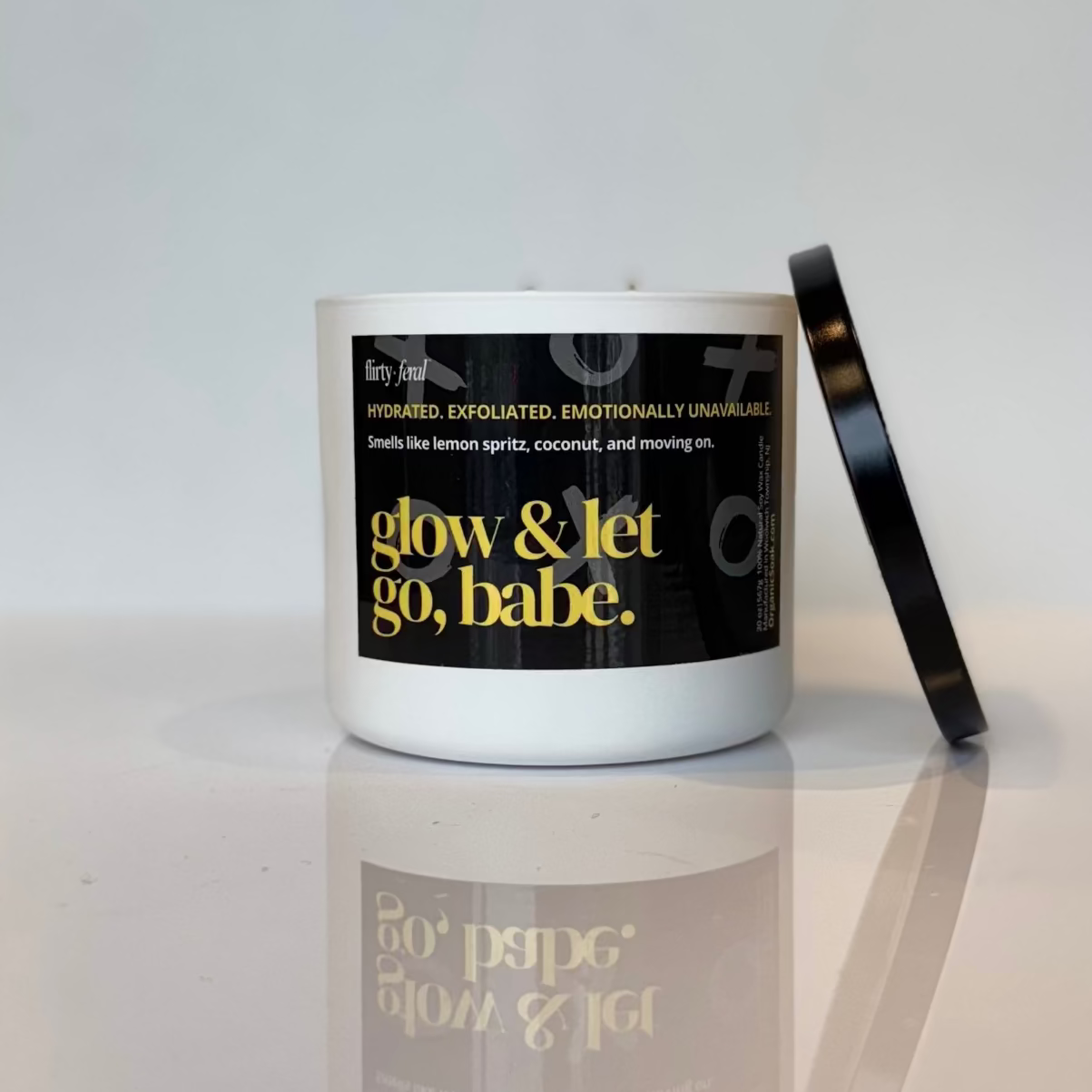 Candle with a black label on a white surface