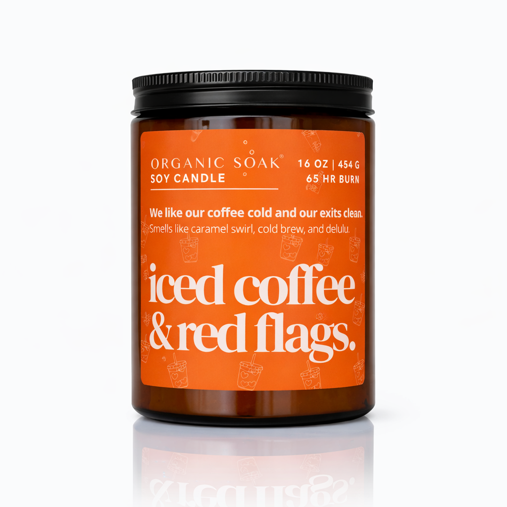 Candle jar with orange label on a white background