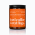 Candle jar with orange label on a white background