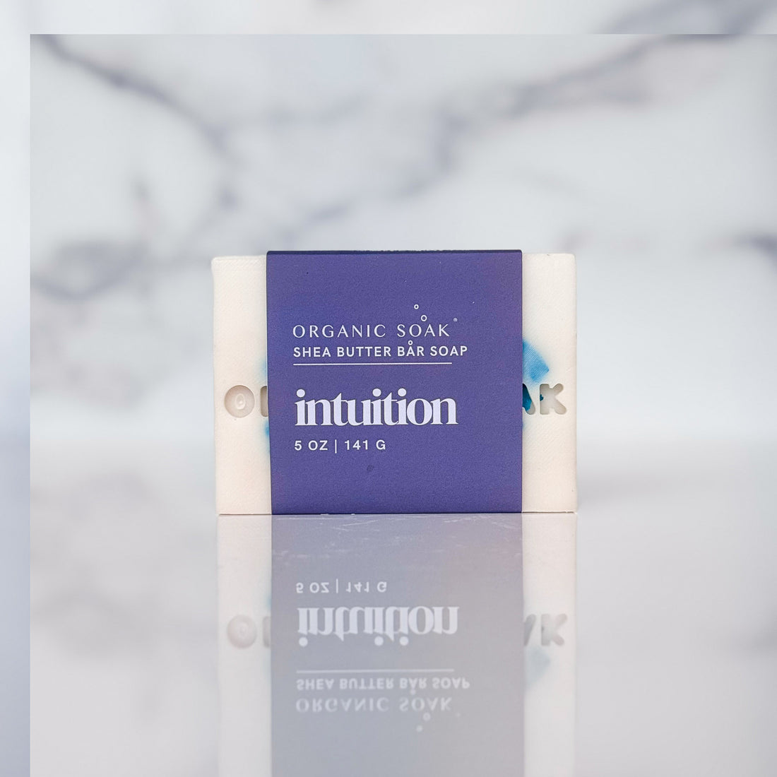 intuition shea butter soap bar against a marble background