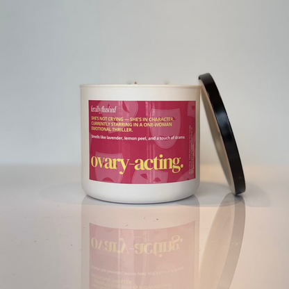 Candle with a pink label on a white surface