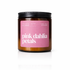 Candle jar with pink label reading &