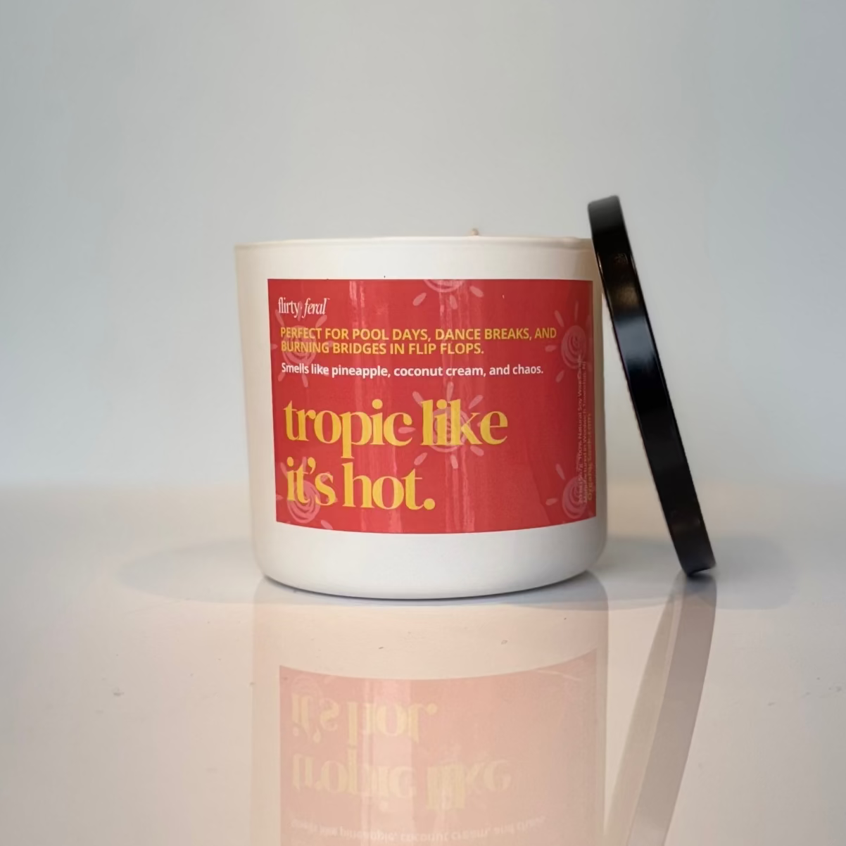 Candle with a red label on a white surface