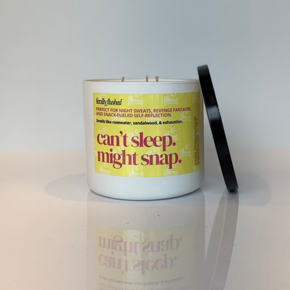 Candle with a yellow label on a white surface