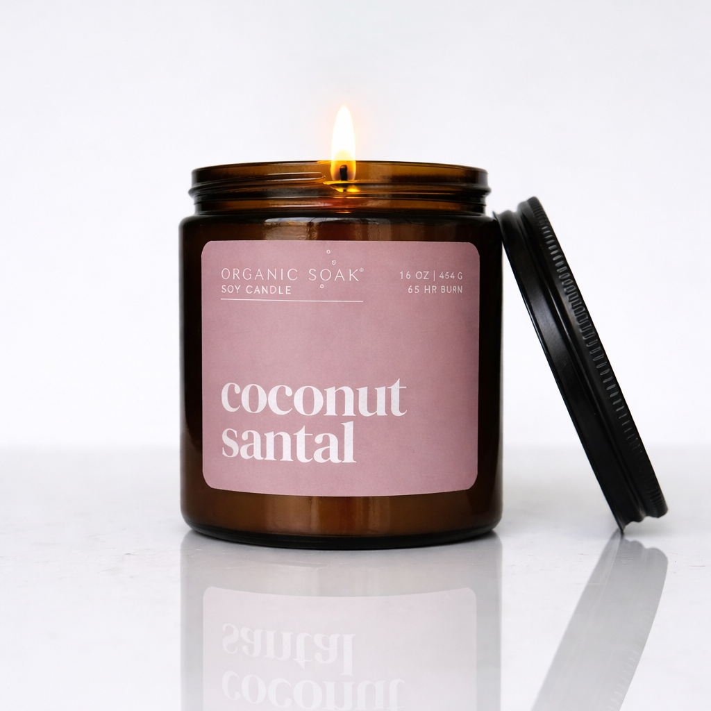 Candle in a glass jar with a pink label on a white background